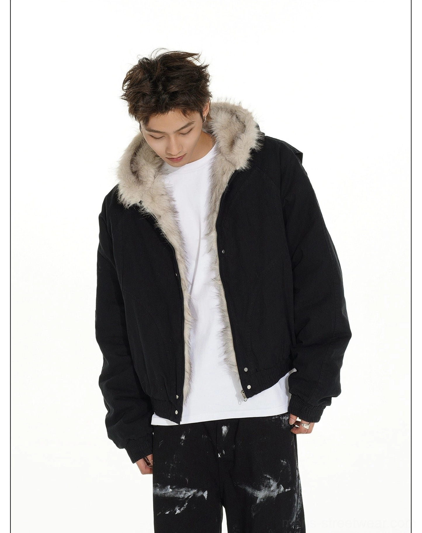 Black cropped faux fur lined bomber jacket shown from a slightly low front angle highlighting the fluffy hood and loose fit