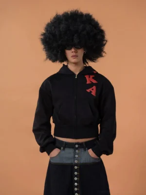 Black cropped full zip hoodie with red raised chest lettering and front pockets styled with high waisted wide leg jeans