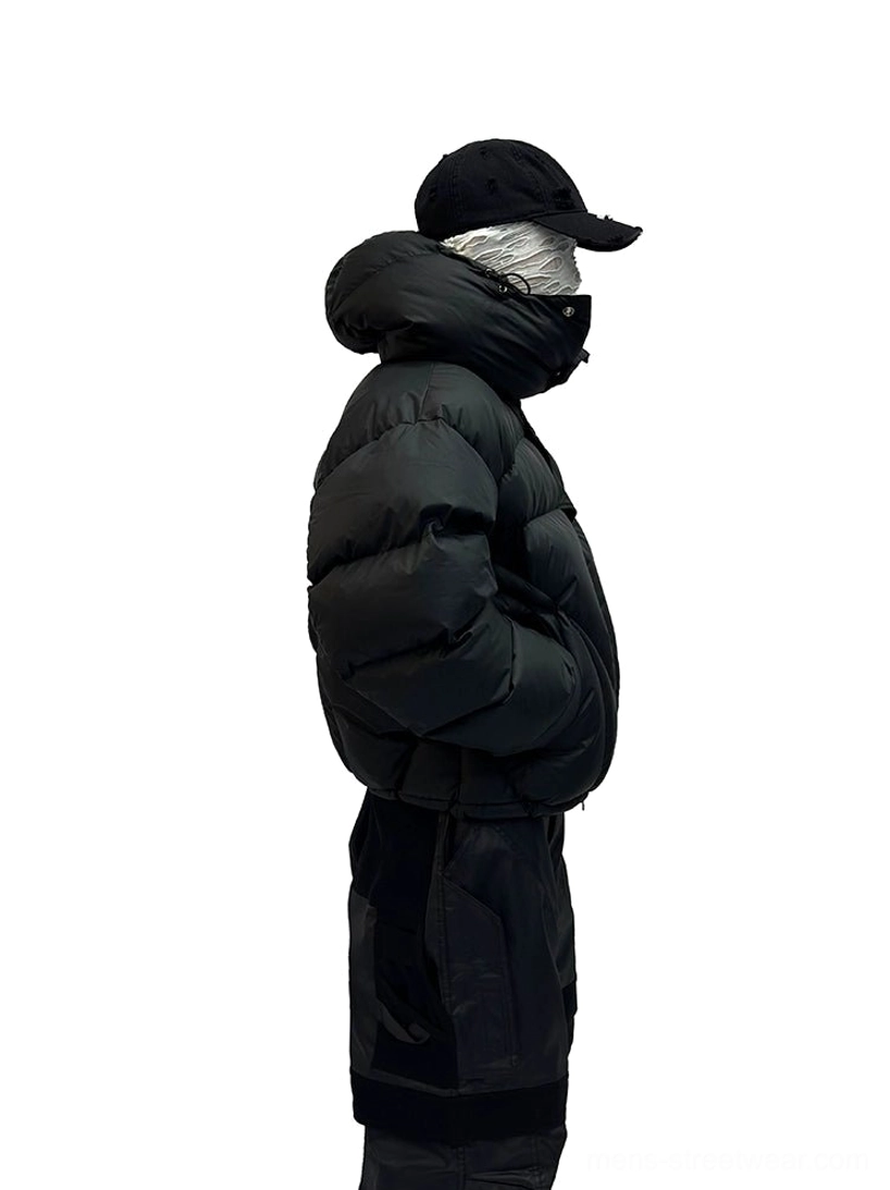 Black cropped hooded puffer jacket side profile showing oversized padded silhouette and short length