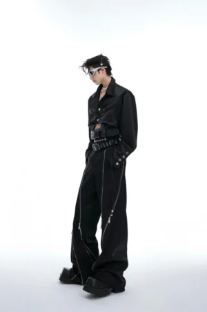 Side view of black cropped long-sleeve shirt with exposed underbust hem, decorative cuffs, wide-leg pants, and futuristic streetwear accessories