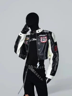 Black cropped PU moto racing jacket with white contrast panels and racing patches shown in front three-quarter streetwear view