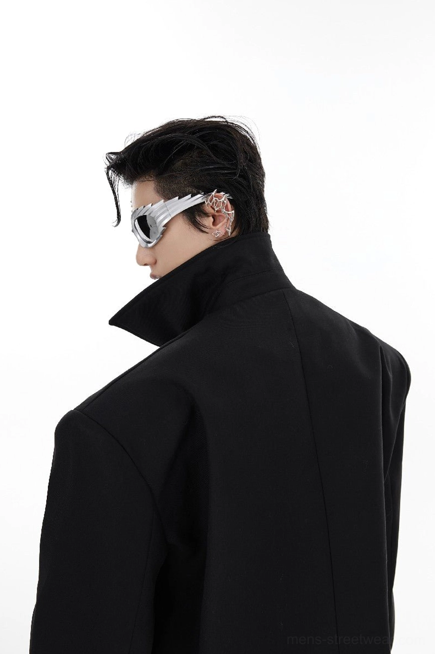 Side back view of black cropped shoulder pad jacket showing high stand collar smooth tailored fabric and structured silhouette