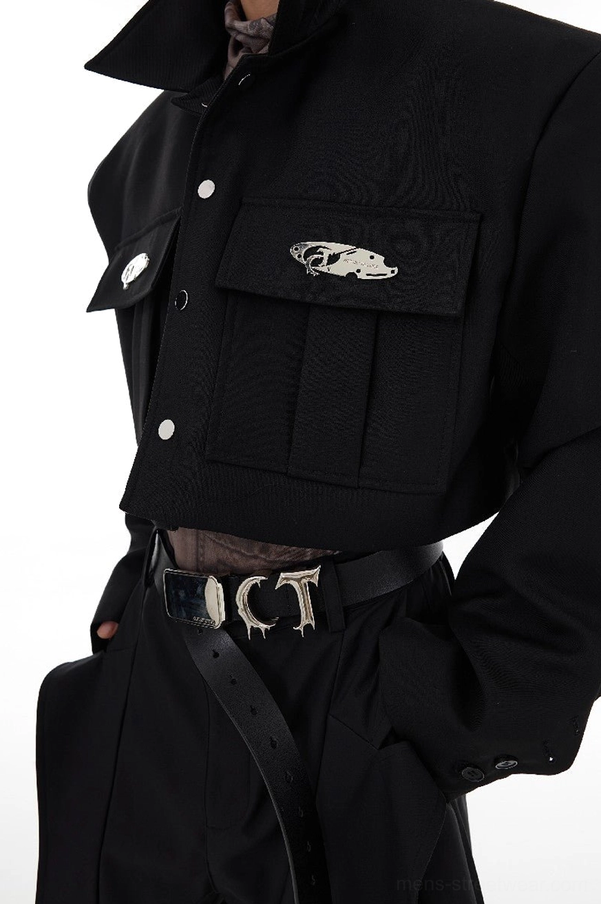 Close-up of black cropped cargo jacket showing snap button front dual flap chest pockets and structured cropped hem