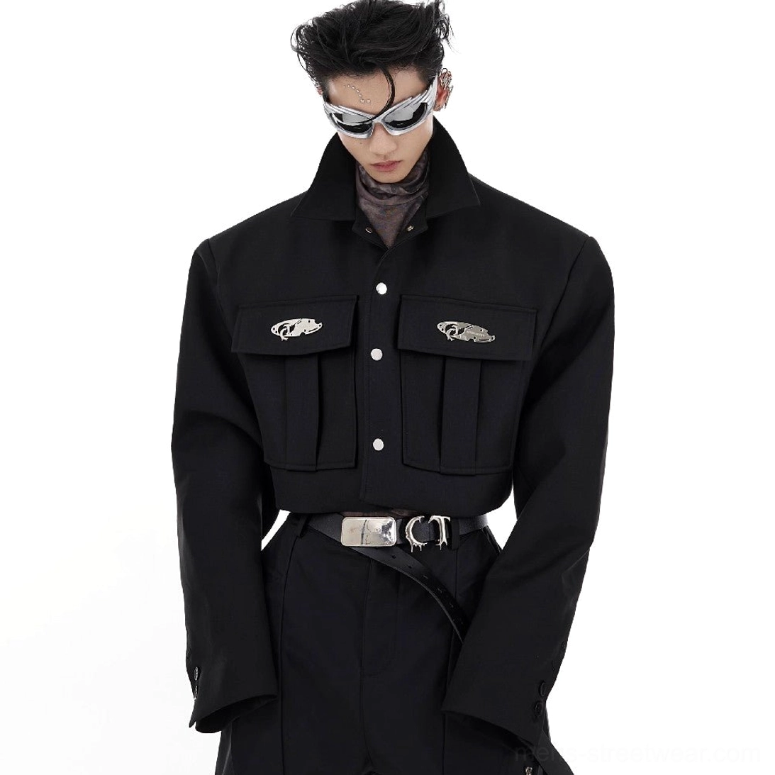 Black cropped shoulder pad cargo jacket front view with metal badge chest pockets snap closure and futuristic streetwear styling