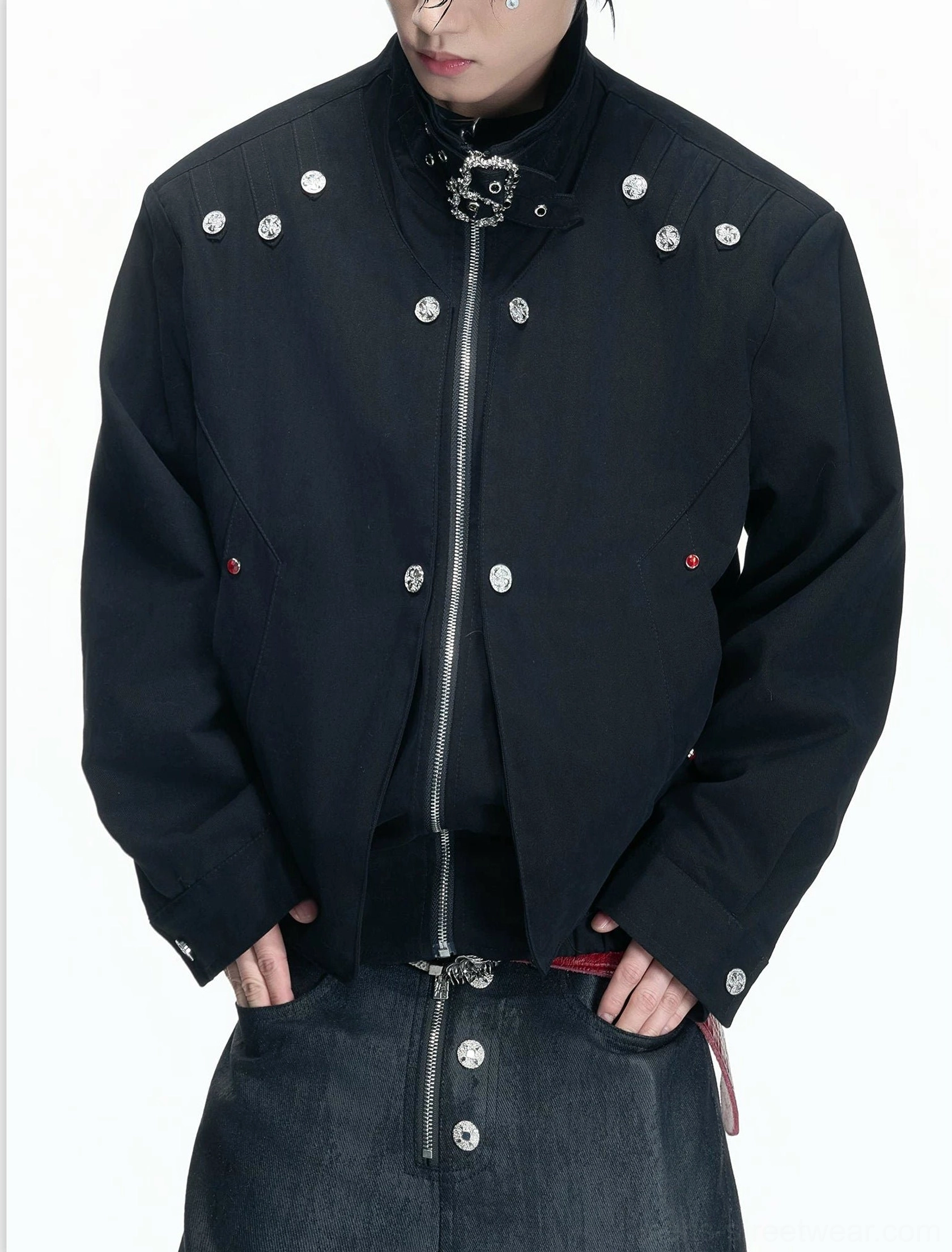 Black cropped stand collar hardware jacket for men styled with jeans, showing front zipper and silver metal button details