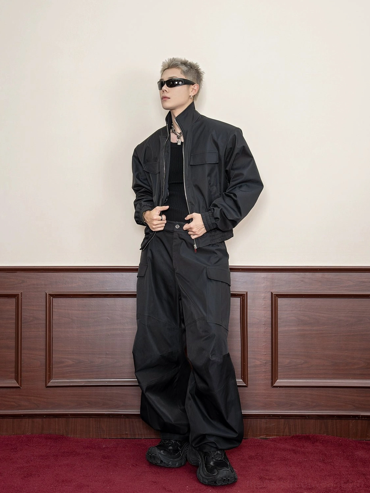 Black cropped utility jacket front full-body view showing stand collar zip closure and relaxed techwear silhouette