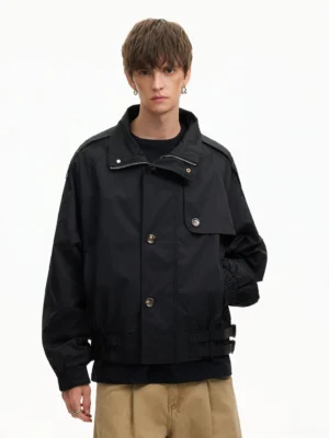 Black cropped utility windbreaker jacket with hidden stand collar button front closure and shoulder epaulets for modern urban streetwear