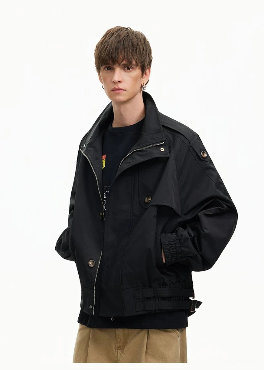 Black cropped windbreaker jacket with hidden button placket adjustable hem straps and modern urban utility silhouette