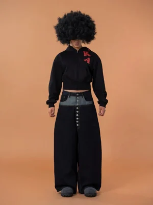 Black cropped zip hoodie with red 3d letter applique worn with wide leg jeans in front full body streetwear look