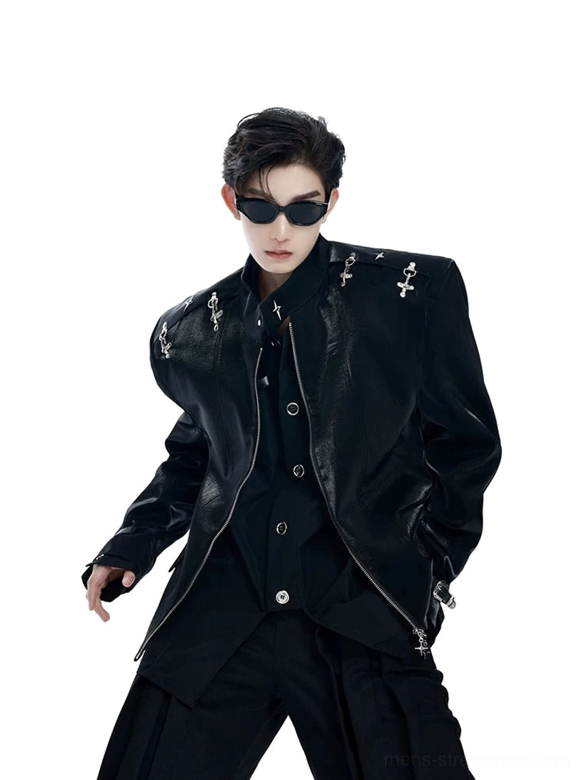 Male model wearing a glossy black cross-decorated leather blazer with oversized shoulders, front zipper, stand collar, and layered Korean streetwear styling