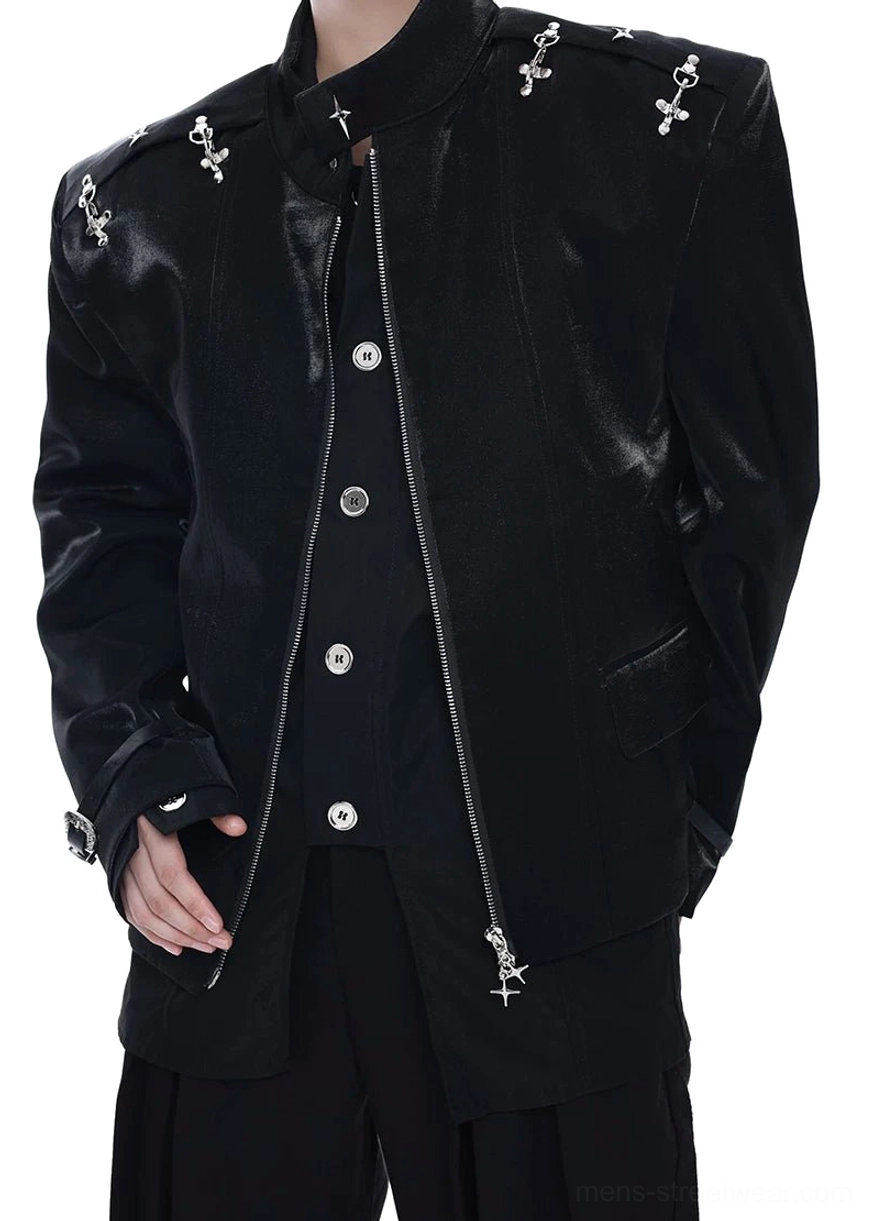 Three-quarter view of a black cross-ornament leather blazer with adjustable buckle cuffs, front zipper, silver buttons, and structured streetwear fit