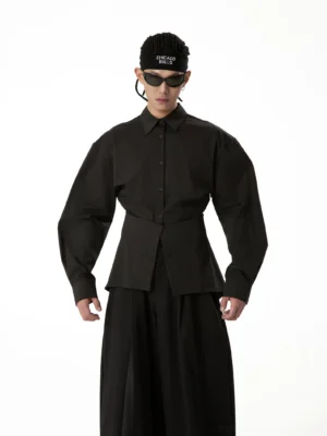 Black crosswrap sculpted waist poplin shirt shown in a full-body front view with pointed collar, structured shoulders, long sleeves, and fitted hourglass waist