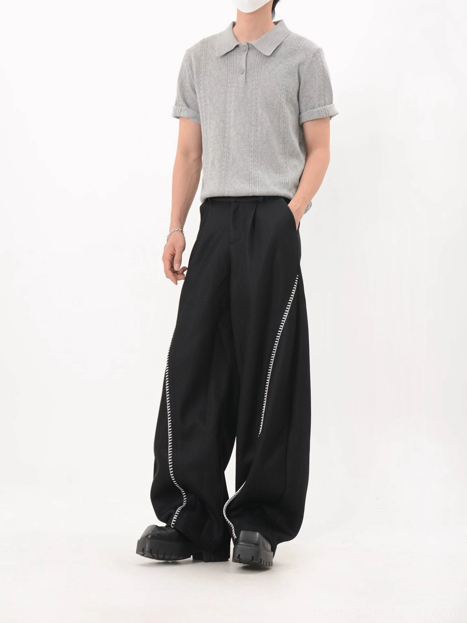 Black wide leg Korean streetwear trousers with curved white side trim and relaxed tailored silhouette front view