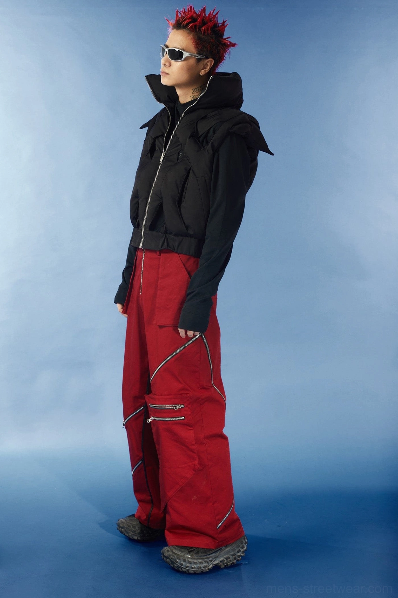 Black cutout puffer vest product image with cropped silhouette padded construction and distinctive crisscross back design