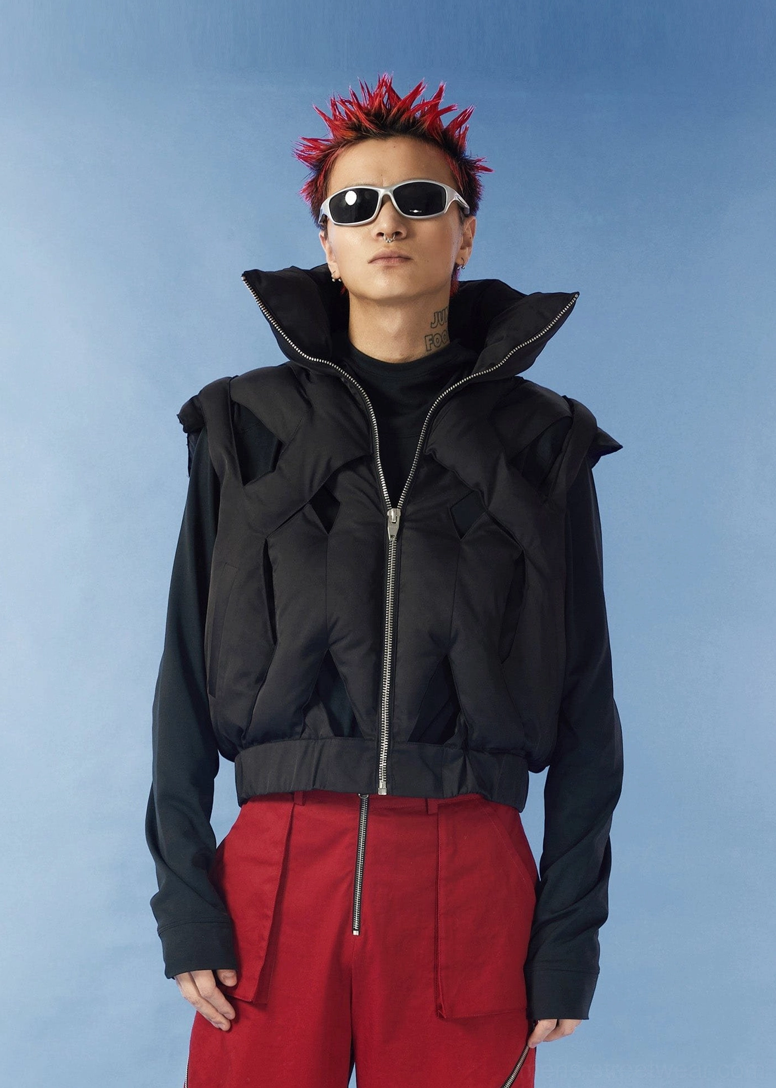 Black cropped cutout puffer vest front view styled over a dark base layer with high fold-over collar and front zip