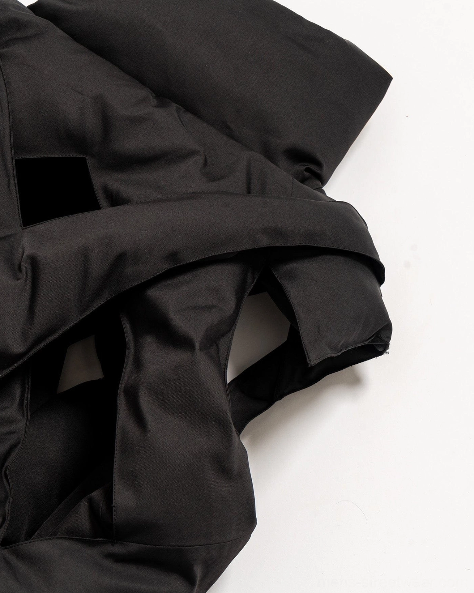 Black cropped cutout puffer vest image for Korean streetwear styling with padded quilted texture and high collar