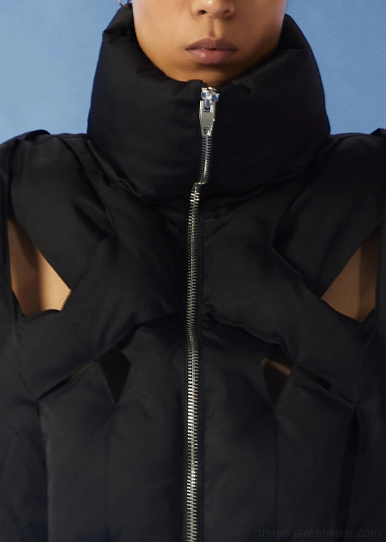 Black cropped cutout puffer vest streetwear image with high stand collar padded body and contemporary layered styling
