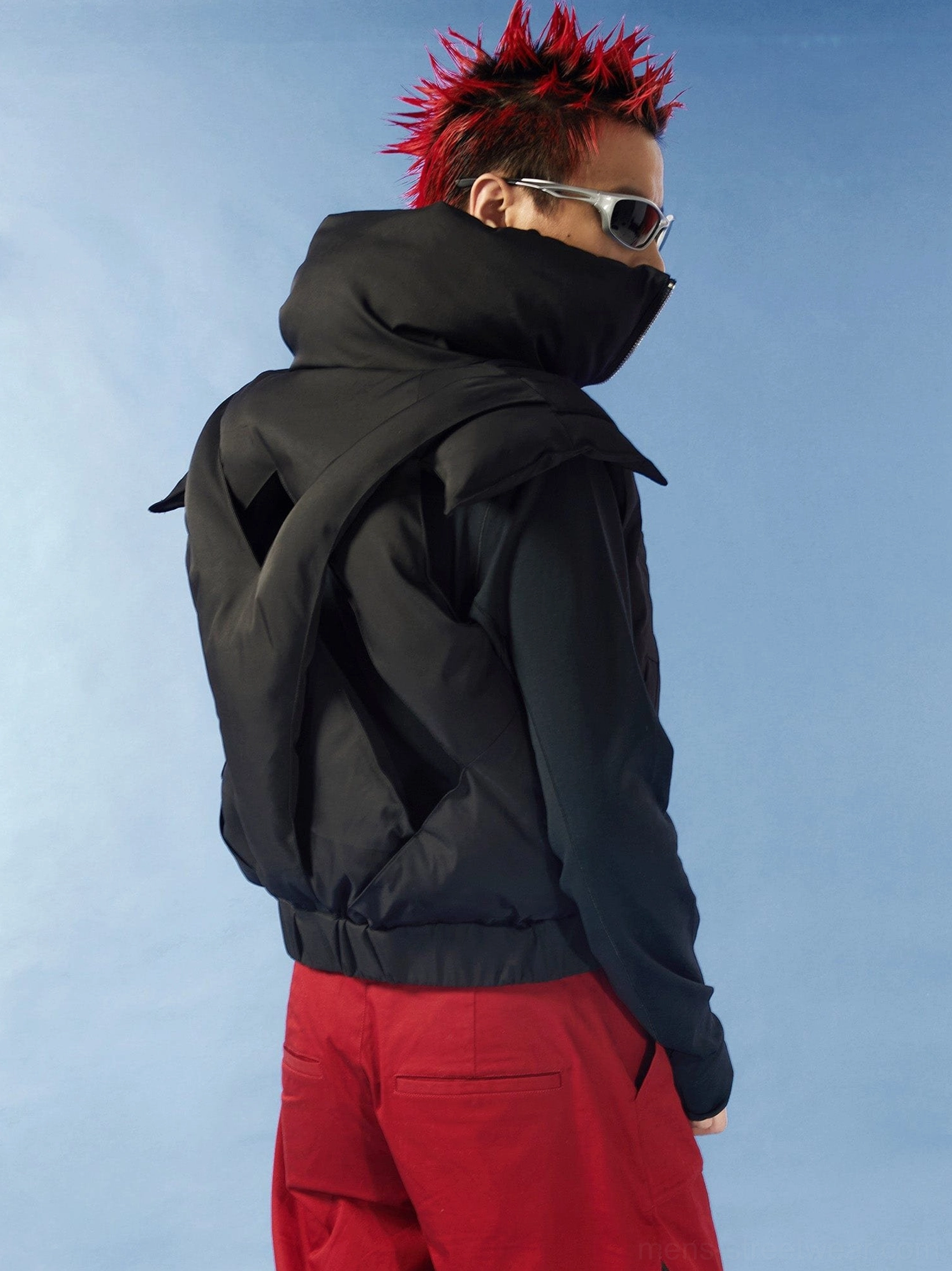 Back side view of cropped black cutout puffer vest with quilted padded panels high foldable collar and open back