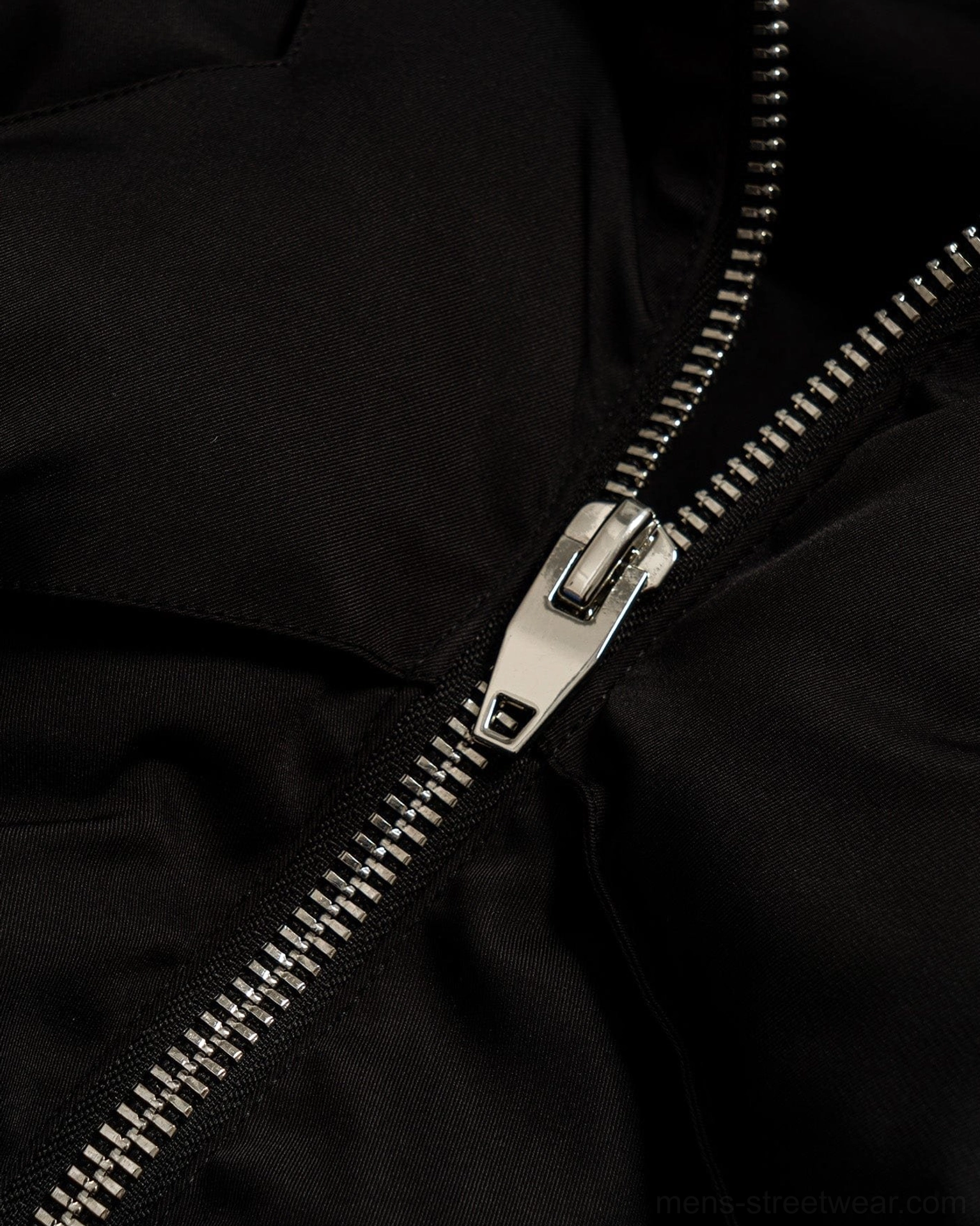 Black Seoul streetwear puffer vest image with distinctive open back cutout design and padded quilted finish