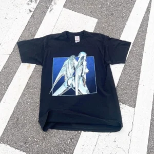 Black cyber angel chrome graphic streetwear t-shirt flat lay on zebra crossing with silver winged android and blue square print