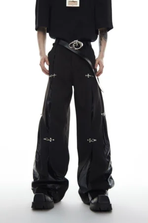 Black deconstructed buckle wide-leg streetwear trousers front view with glossy side panels and silver hardware