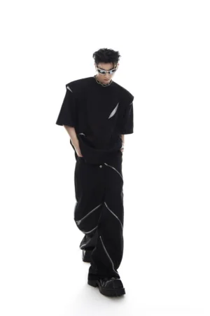Black deconstructed oversized streetwear tee with diagonal mesh cutouts styled with wide leg zipper pants in a futuristic Seoul fashion outfit