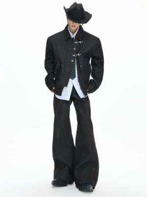 Front view of a model wearing the black denim cavalry jacket with red contrast stitching and matching wide-leg trousers