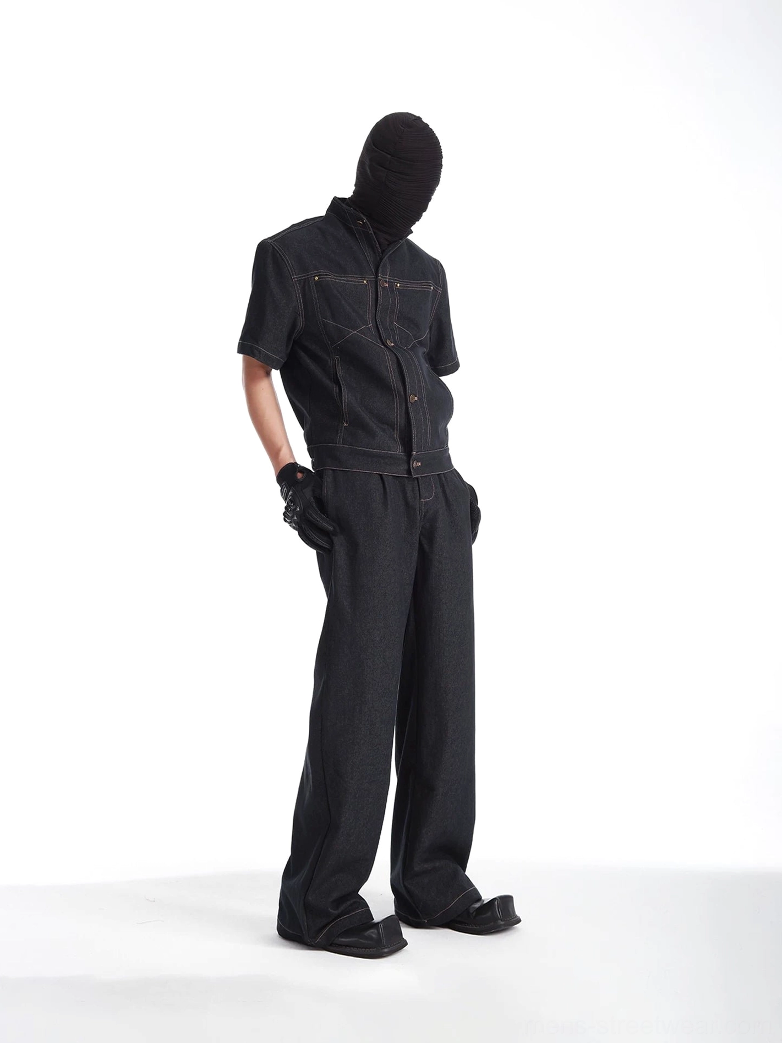 Black denim jacket and relaxed wide-leg jeans streetwear outfit shown from the side with tailored pocket stitching