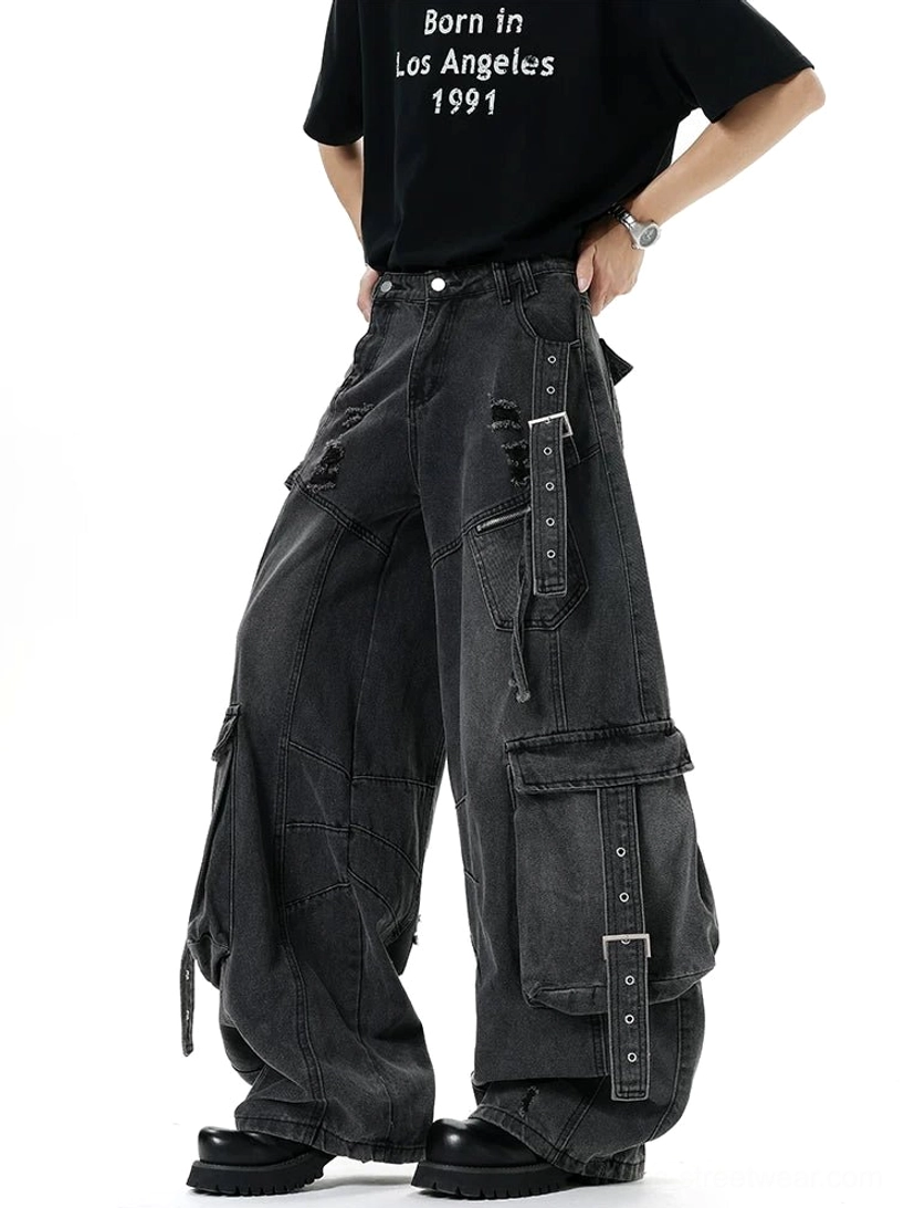 Side rear view of black distressed cargo jeans with structured adjustable strap pockets, detailed stitching, and oversized wide-leg fit