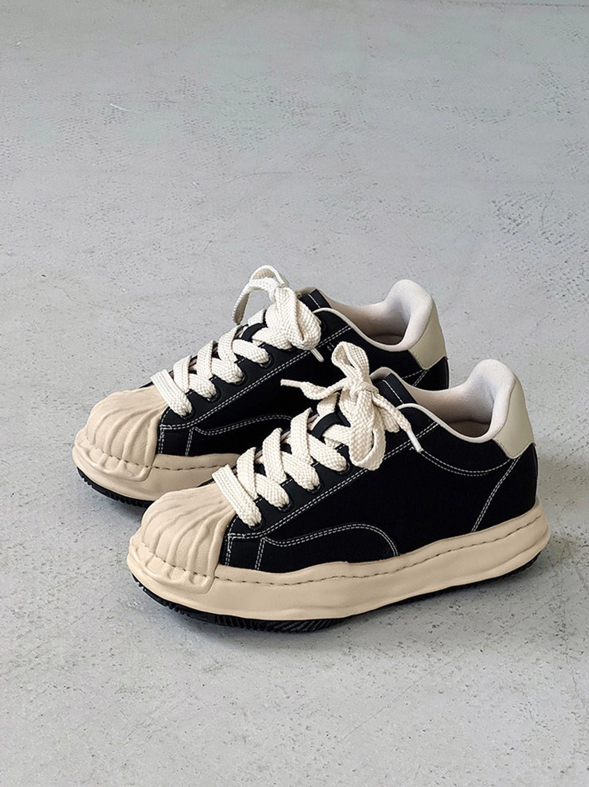 Black distressed court sneakers with thick platform sole for Korean streetwear and Seoul fashion outfits