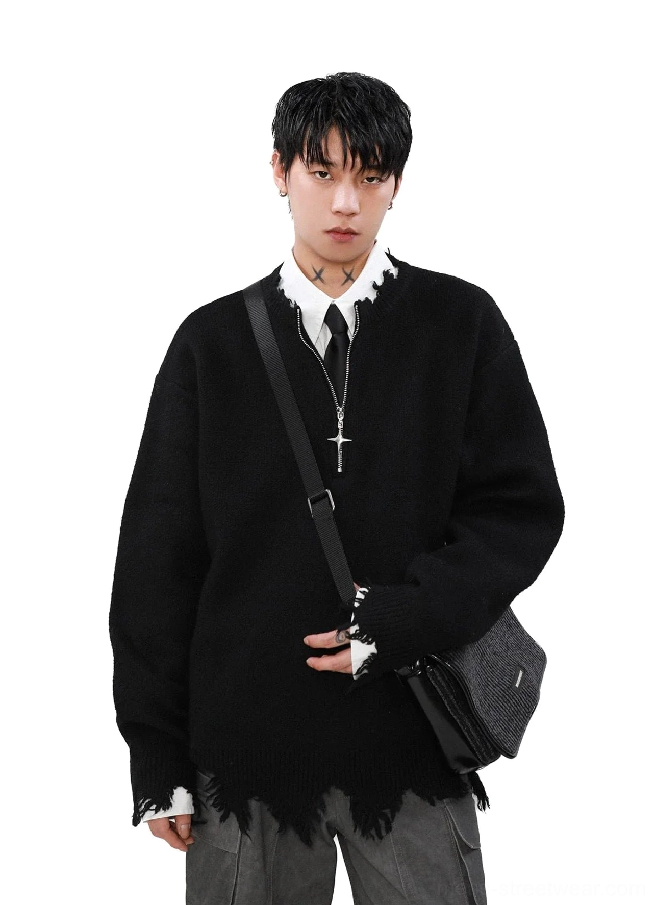 Black distressed cross-zipper half-zip sweater layered over white shirt and tie with grey cargo pants