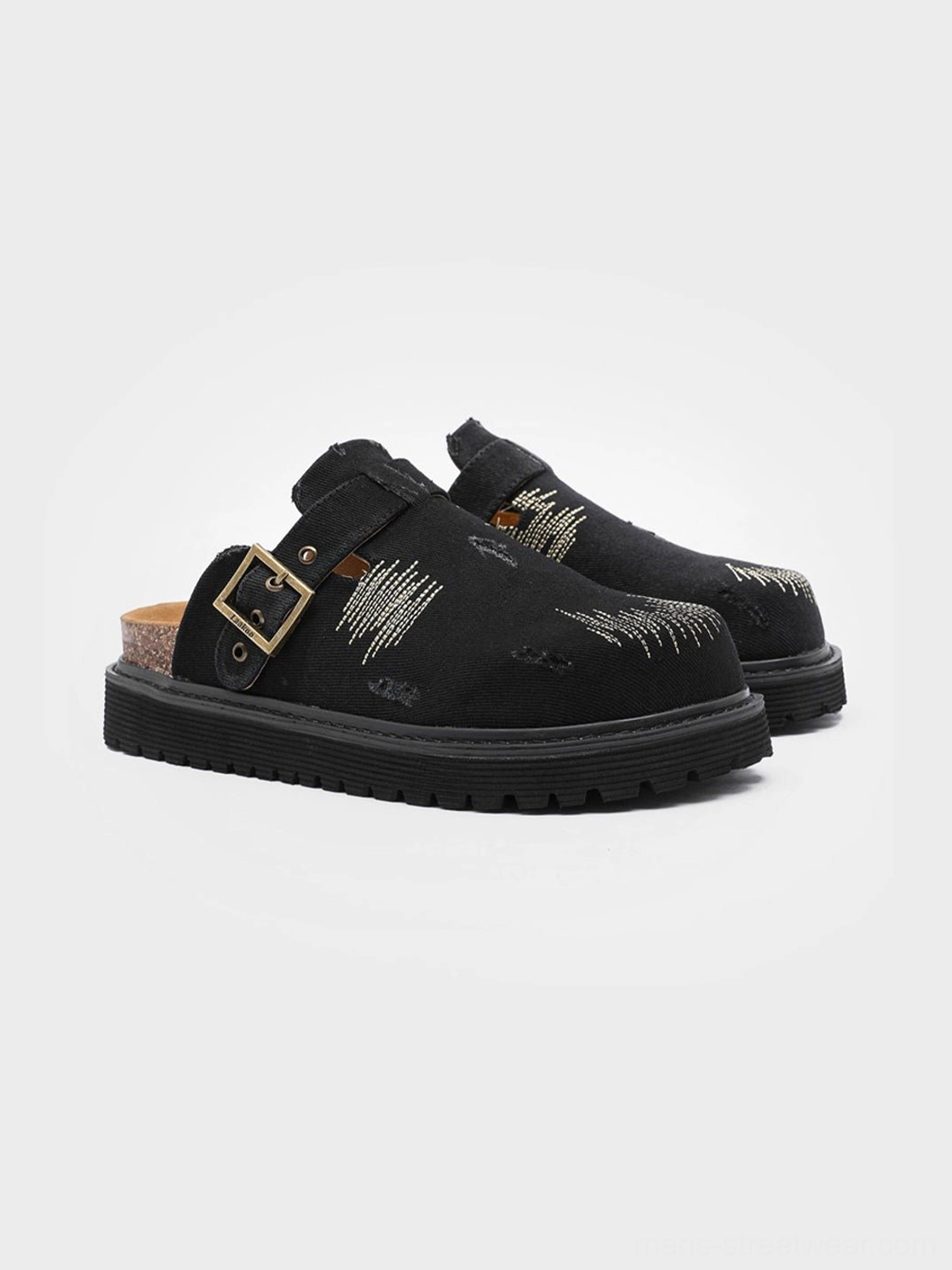 Black distressed denim platform mule clogs with visible stitching, antique buckle detail, cork-style footbed and thick platform outsole