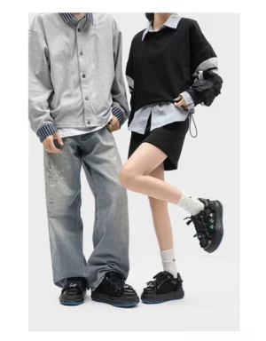 Black distressed embroidered platform sneakers worn by a couple in casual Korean streetwear outfits