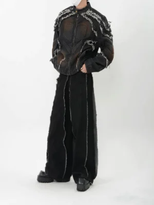 Black washed distressed denim jacket with frayed trim shown in three quarter side view