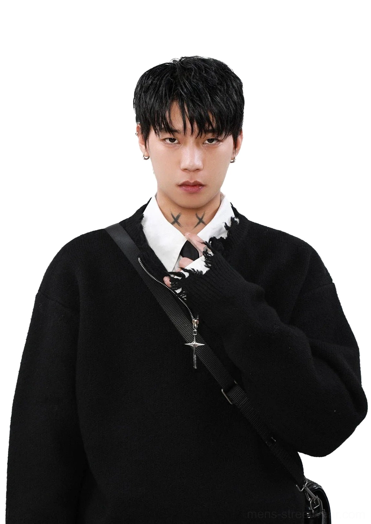 Close-up black distressed half-zip sweater showing silver cross zipper charm, frayed neckline, and thick knit texture