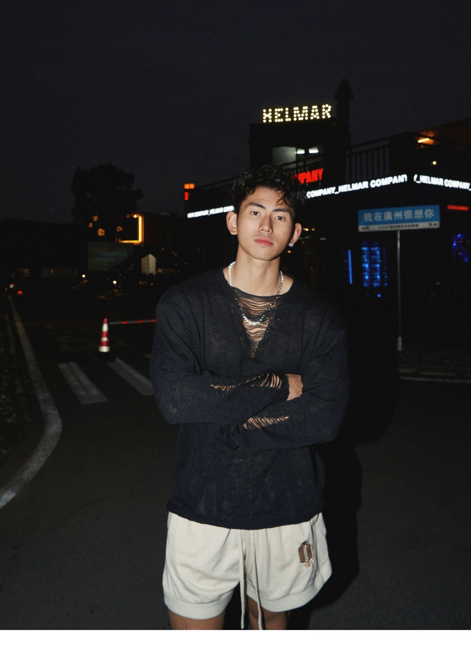 Black distressed lace-up knit shirt with textured finish and relaxed fit worn in a Seoul-inspired streetwear look