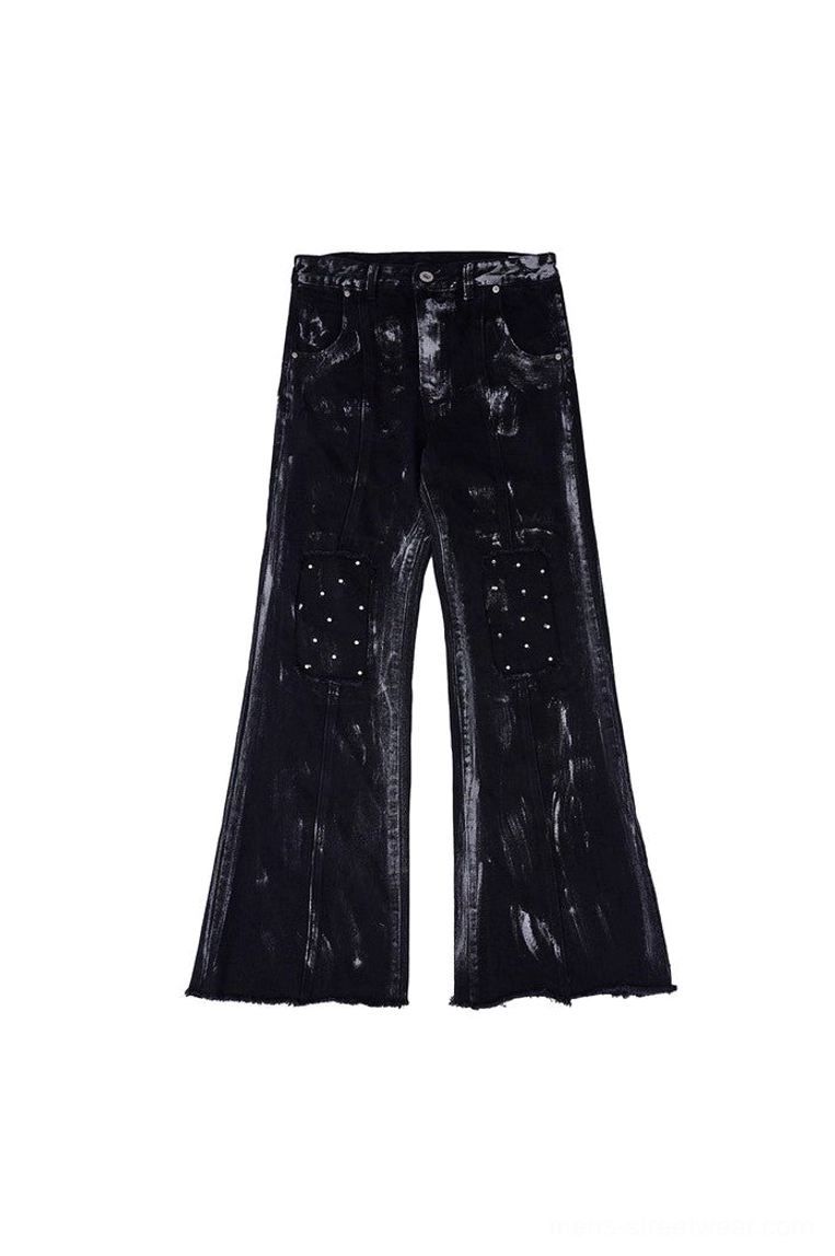 Black distressed wide-leg jeans flat lay back view featuring riveted knee patch pockets, rear pockets, and raw flared hems