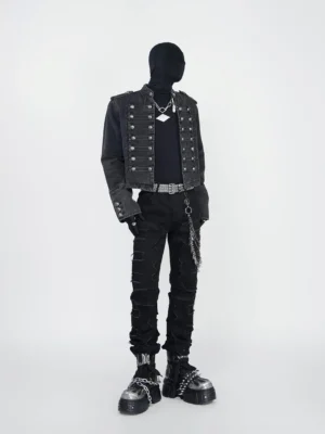 Full front view of black distressed spike chain jeans with shredded denim, stacked slim legs, studded belt, and punk streetwear styling