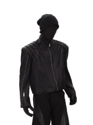 Black distressed studded PU leather cropped rider jacket styled with beanie gloves and wide leg black pants front three quarter view