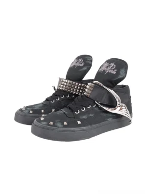 Front three-quarter view of black distressed studded wing strap high-top canvas sneakers with silver pyramid toe studs and spiked ankle straps