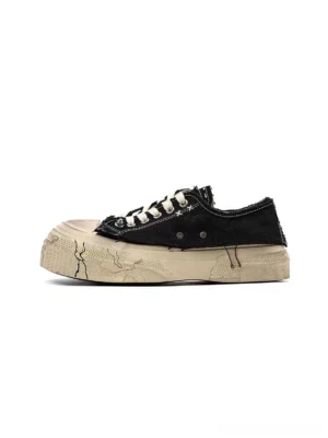 Side view of black distressed washed canvas platform sneakers with frayed panel edges, off-white laces, and cracked-look thick soles