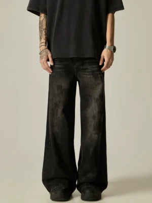 Black washed distressed wide-leg denim jeans front view showing relaxed fit, classic waistband, fly, and faded texture