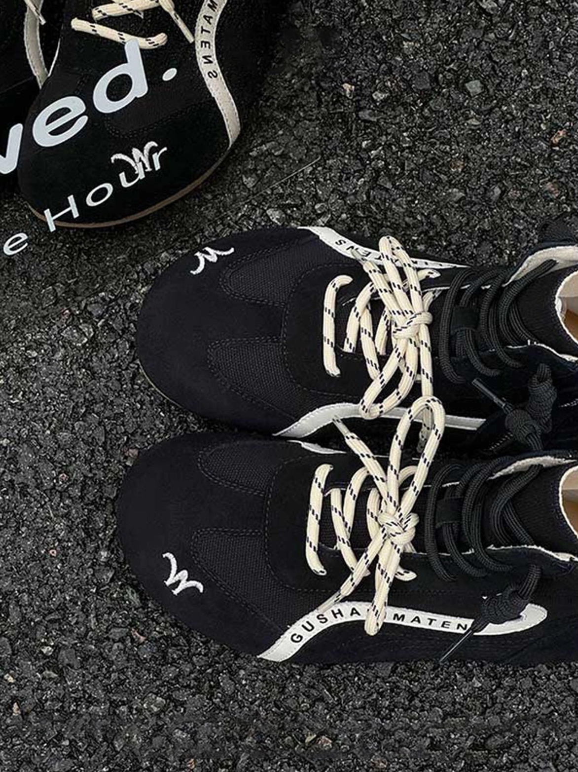 Black nubuck suede racing training boots with white contrast side stripe, dual lace options, and high-top streetwear silhouette