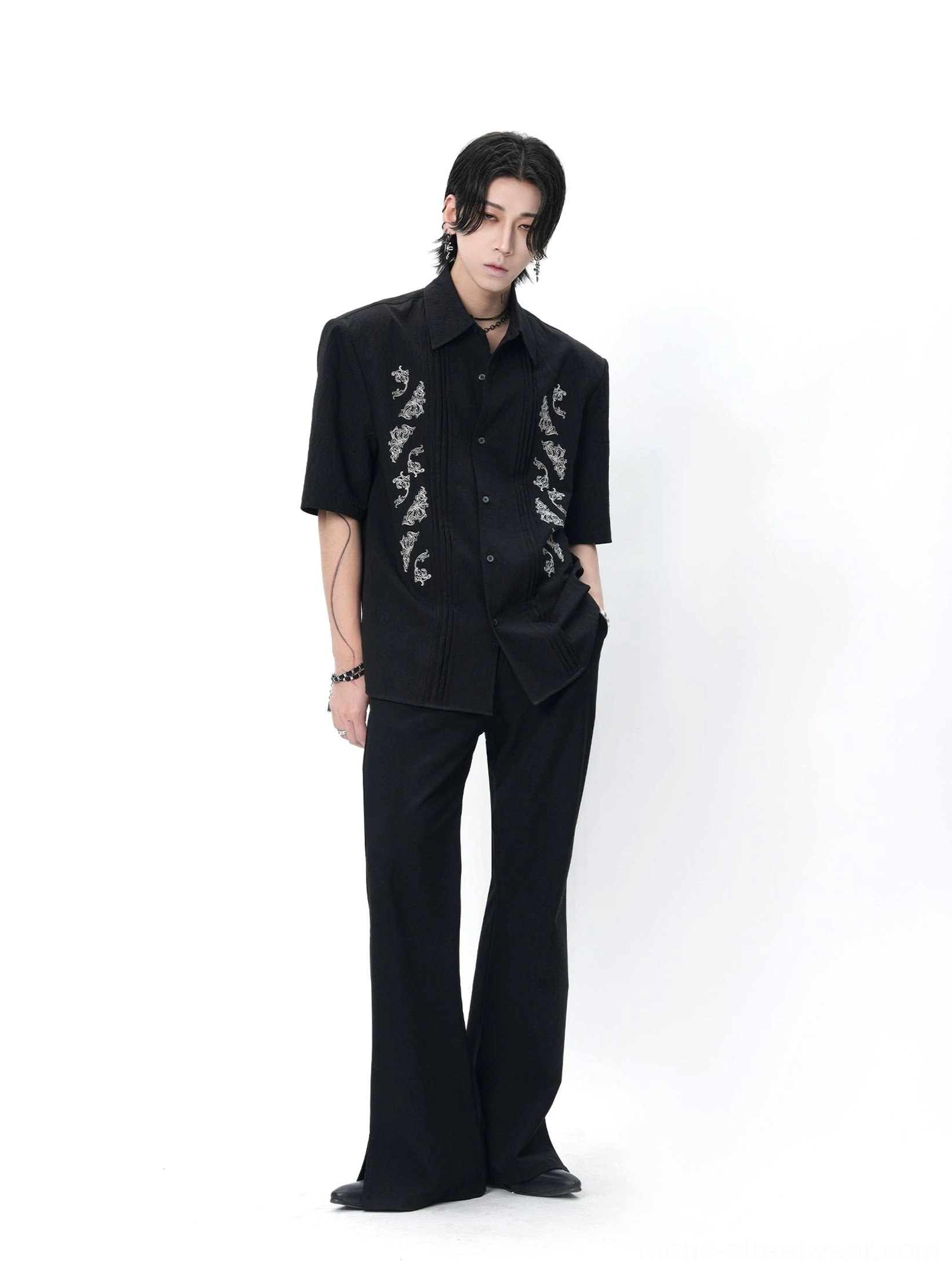 Black dragon embroidered Cuban shirt shown from the side with wide-leg trousers and layered accessories