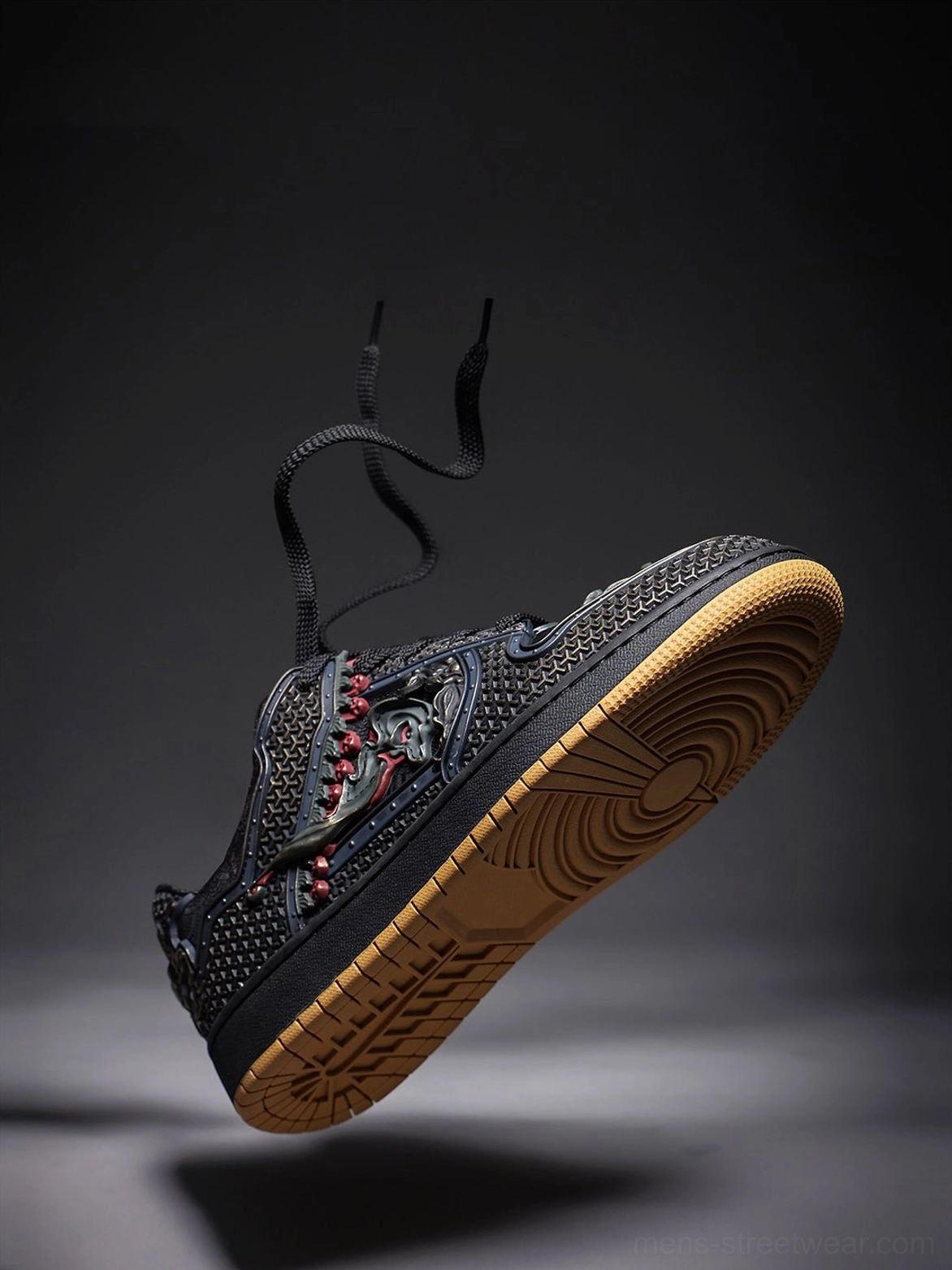 Close product view of black dragon low-top sneakers with bronze-inspired ornamentation and textured synthetic textile upper