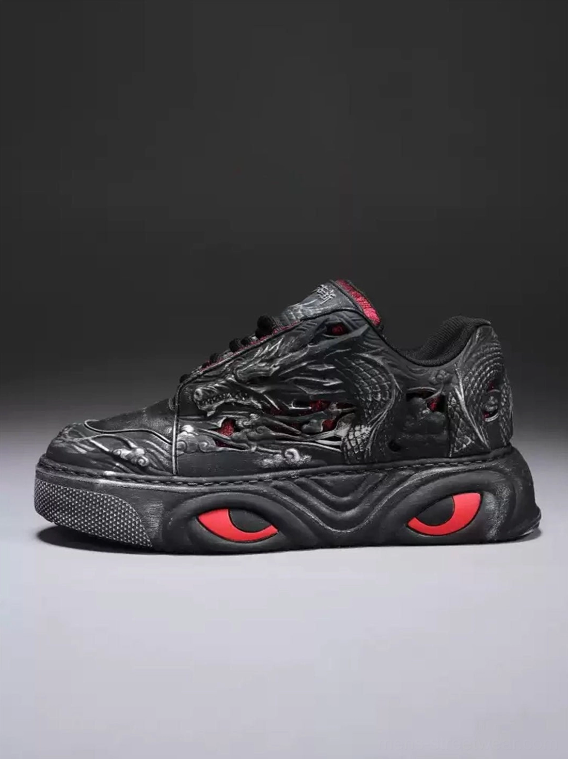 Black dragon relief chunky platform sneaker right side profile showing embossed dragon design and red sole accents