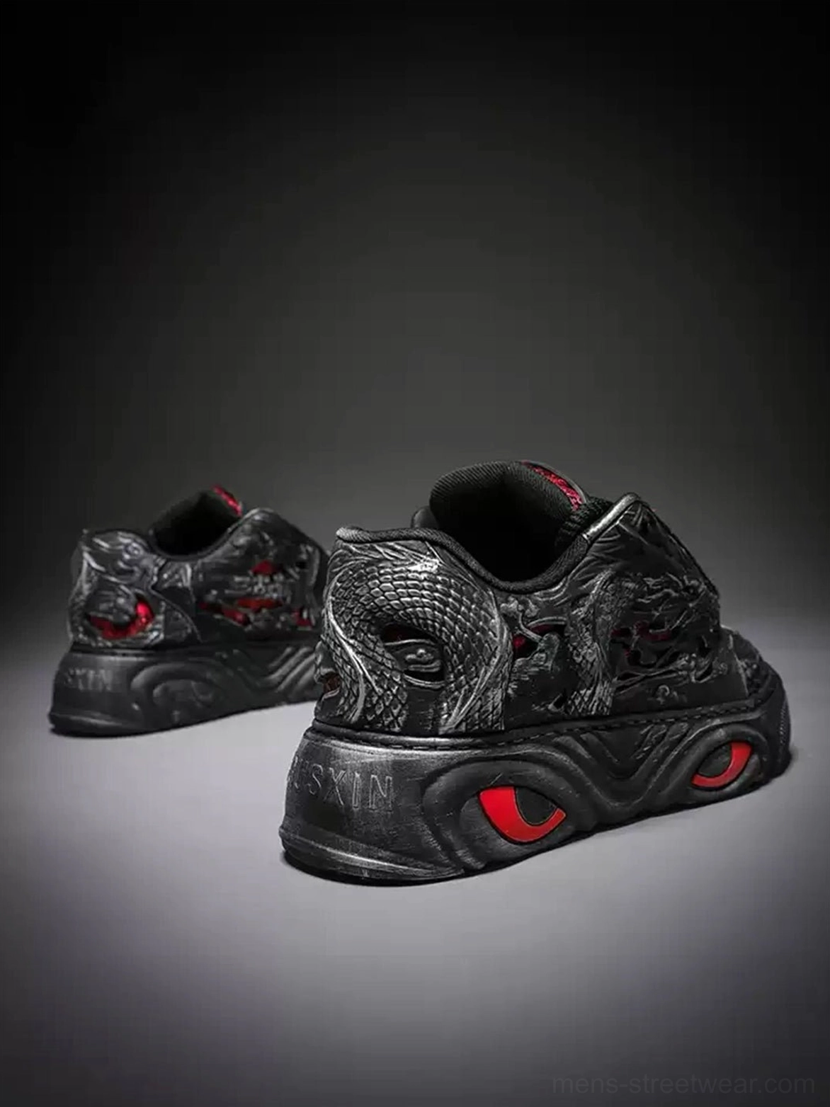 Black dragon relief chunky platform sneakers rear lateral view highlighting heel construction and red eye sole accents