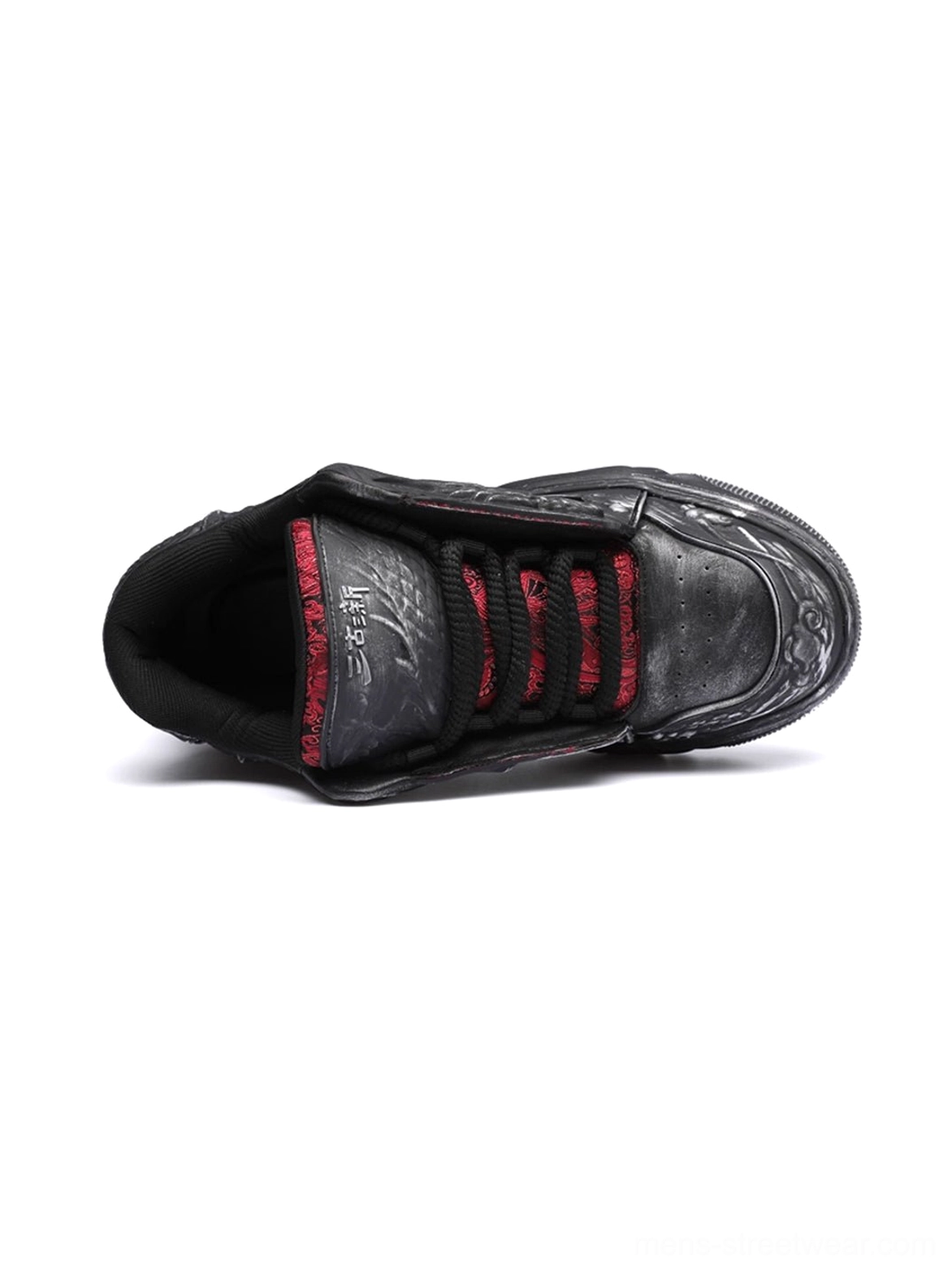 Top view of black dragon relief chunky platform sneaker showing red inner lining lace area and chunky outsole edge