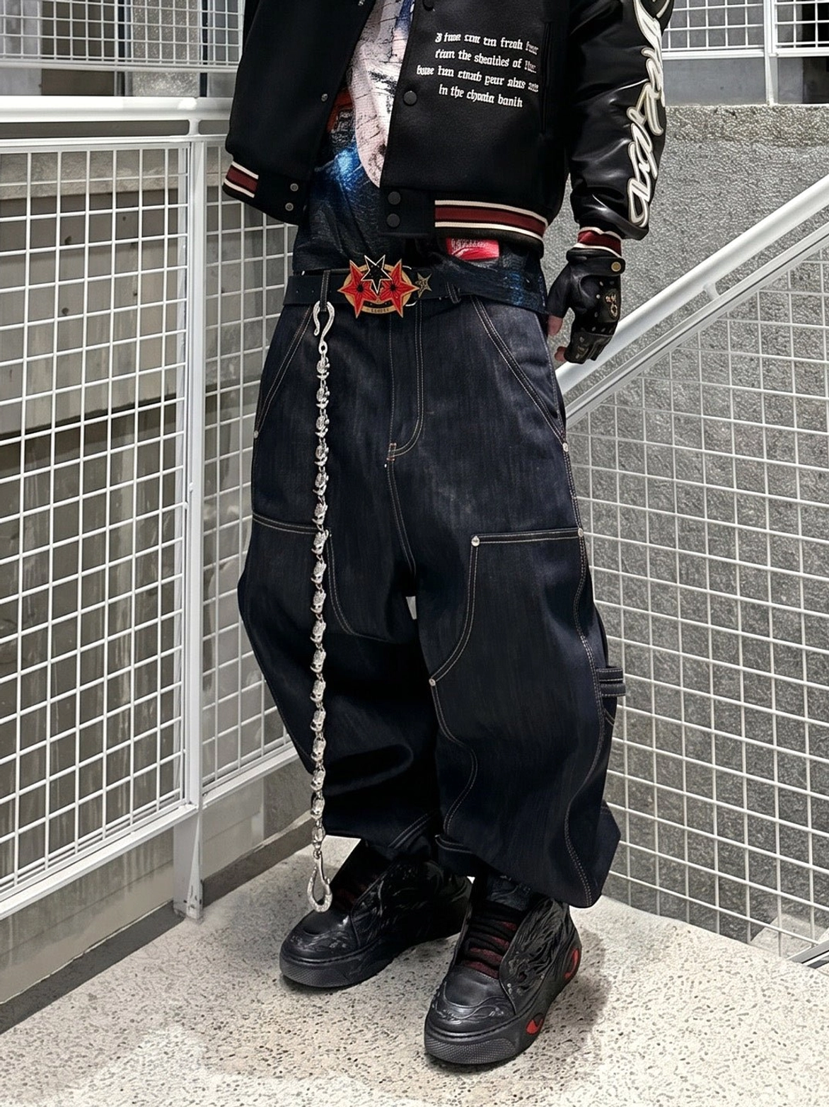 Black dragon relief chunky platform sneakers styled with varsity jacket baggy jeans and chain belt Y2K streetwear outfit