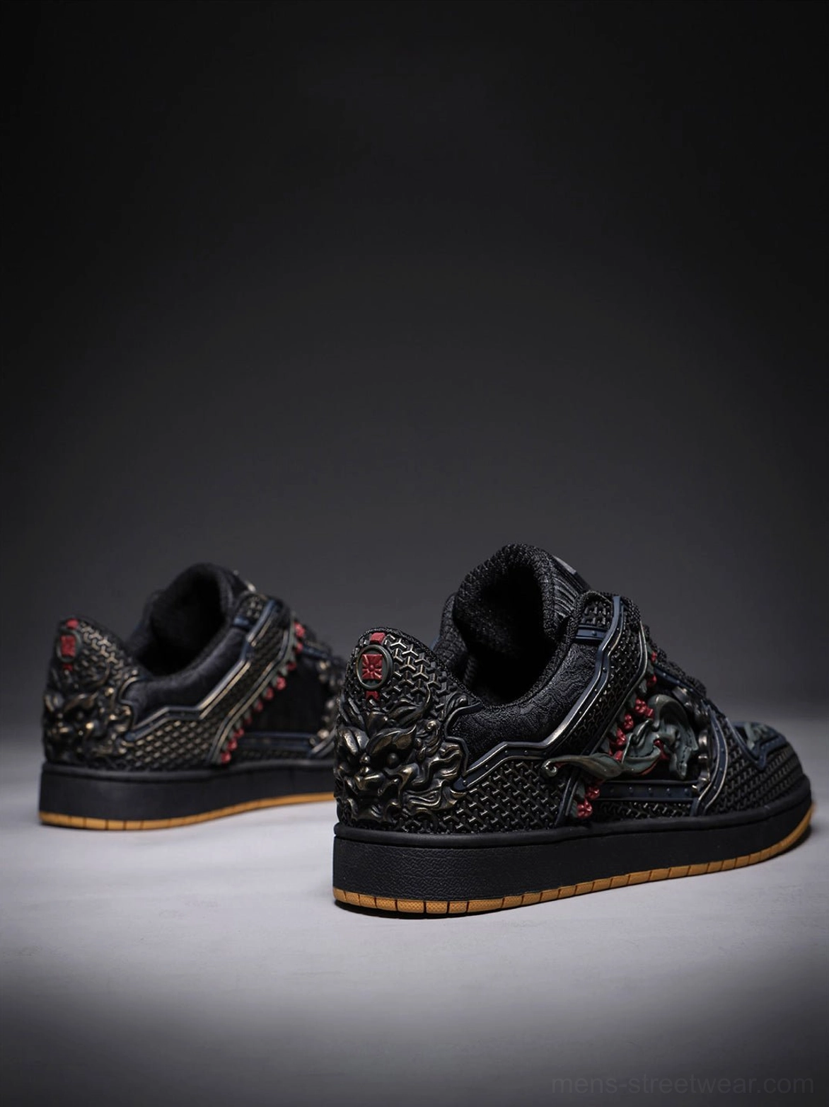 Low rear three-quarter view of black dragon streetwear sneakers with detailed heel ornaments and gum rubber outsoles